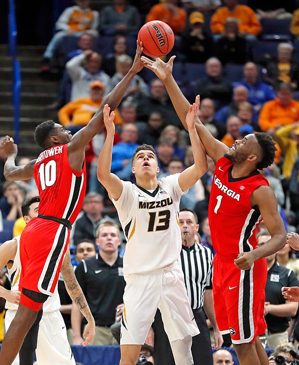 Missouri's Michael Porter Jr. reaches for a rebound between Georgia's Teshaun Hightower (10) and Yante Maten (1) during the second half of Thursday afternoon's SEC Tournament game in St. Louis.