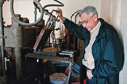 In this file photo, retired businessman Lionel Betancourt lifts a recording die on a Finebilt record press in San Benito, Texas. Betancourt donated equipment from San Benito's legendary Ideal Recording Co. for display in the Texas Conjunto Music Hall of Fame and Museum. (AP Photo/Valley Morning Star)