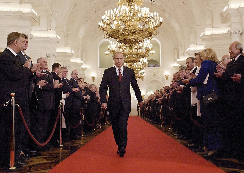 FILE - In this file photo taken on Friday, May 7, 2004, Russian President Vladimir Putin walks through St.George's Hall to take part in an inauguration ceremony in Moscow's Kremlin, Russia. Vladimir Putin looks more invincible than ever before in his 18 years in power, after Russians invaded Ukraine, blanket-bombed Syria and hacked the U.S. election campaign. (AP Photo/Alexander Zemlianichenko, Pool, File )