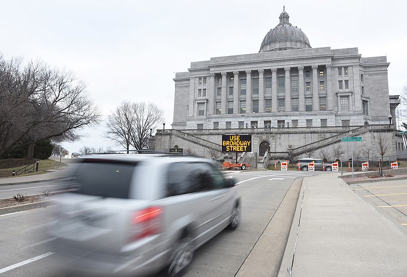 A minivan prepares to turn right onto Broadway Street off of West Main Street on Wednesday, March 7, 2018. Temporary road blocks were put into place preventing drivers from taking West Capitol Avenue.