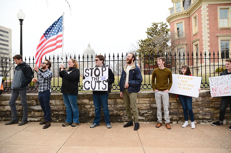 Protestors stand in front of the Governors Mansion during a demonstration Saturday encouraging legislators to remove proposed budget cuts to higher education as part of the upcoming annual budget.