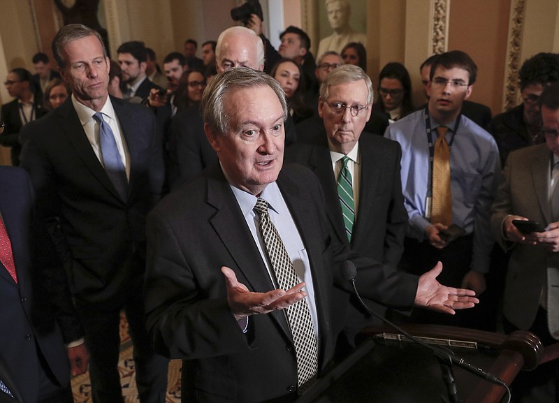 FILE - In this March 6, 2018, file photo, Sen. Mike Crapo, R-Idaho, chairman of the Senate Banking Committee, joined by, Sen. John Thune, R-S.D., left, and Senate Majority Leader Mitch McConnell, R-Ky., right, talks to reporters as the Senate moves closer to passing legislation to roll back some of the safeguards Congress put in place to prevent a repeat of the 2008 financial crisis, at the Capitol in Washington. Burrowed within new Senate legislation to roll back restraints on banks is a break from data reporting requirements for lenders making certain levels of mortgage loans.  (AP Photo/J. Scott Applewhite, File)