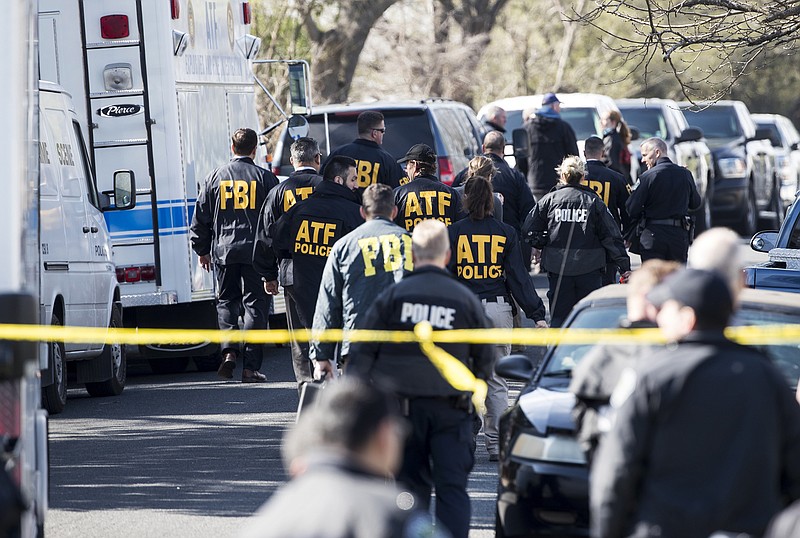 Authorities work on the scene after multiple explosions in Austin on Monday, March 12, 2018. Police are responding to another explosion Monday, that badly injured a woman, hours after a package bomb killed a teenager and wounded a woman in a different part of the city. (Ricardo B. Brazziell/Austin American-Statesman via AP)