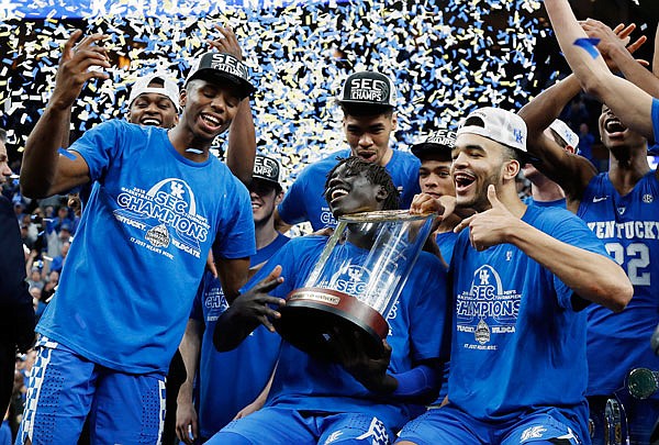 Kentucky players celebrate Sunday after beating Tennessee 77-72 in the championship game of the Southeastern Conference Tournament in St. Louis.