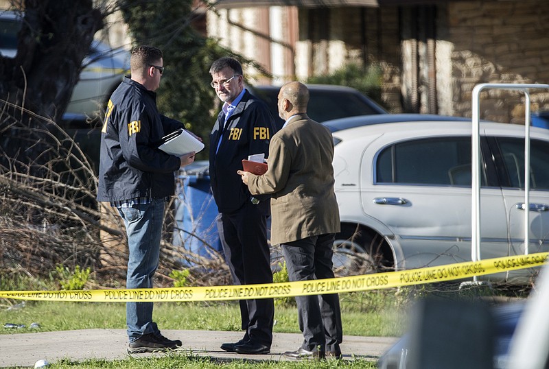 Authorities investigate the scene after multiple explosions in Austin on Monday, March 12, 2018. Police are responding to another explosion Monday, that badly injured a woman, hours after a package bomb killed a teenager and wounded a woman in a different part of the city. (Ricardo B. Brazziell/Austin American-Statesman via AP)