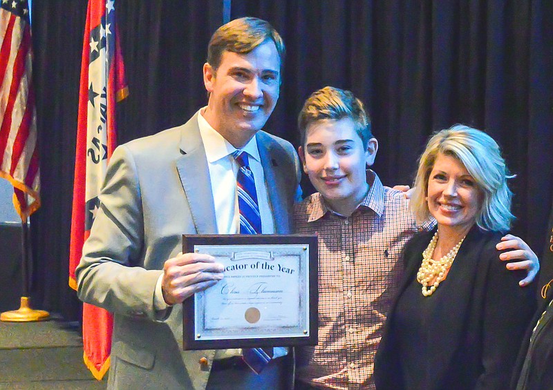 University of Arkansas at Hope-Texarkana Chancellor Chris Thomason, left, is seen with his son, Allen Thomason, and wife, Penny Thomason. The chancellor recently was named Hempstead County Educator of the Year by the Hope-Hempstead County Chamber of Commerce. (Submitted photo)