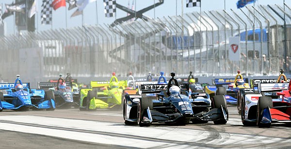 The field races into turn one at the start of Sunday's IndyCar Grand Prix of St. Petersburg in St. Petersburg, Fla.