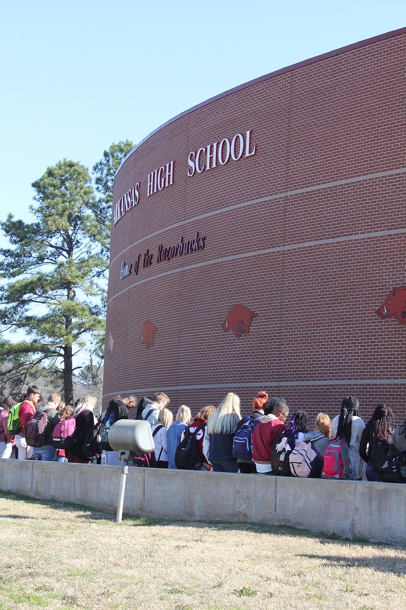 Arkansas High School students gather Wednesday, March 14, 2018, outside the school in Texarkana, Ark., to take part in #NationalWalkoutDay. The event observed 17 minutes of silence, one for each person who died in the Parkland, Fla., school shooting on Valentine's Day.