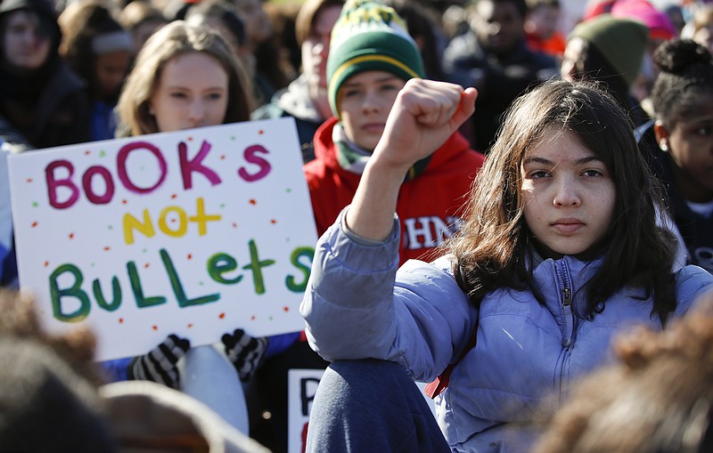 Students sit in silence as they rally in front of the White House in Washington, Wednesday, March 14, 2018. Students walked out of school to protest gun violence in the biggest demonstration yet of the student activism that has emerged in response to last month's massacre of 17 people at Florida's Marjory Stoneman Douglas High School. (AP Photo/Carolyn Kaster)