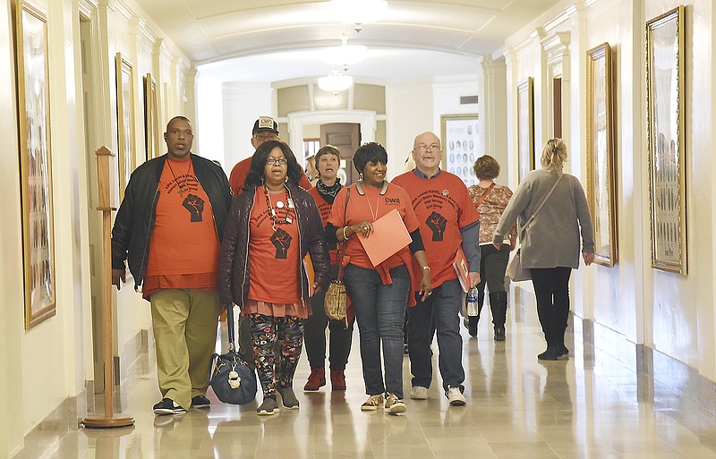 Julie Smith/News Tribune 
Members of Communications Workers of America or CWA Local 6355, AFL-CIO, were in the Capitol Wednesday to lobby legislators on issues of state employee pay raises, merit-based employment and unionization. This group is from the Kansas City area and visited representatives from their respective districts. They are, from left, Cornell Allan, Jacqeline Scott, Jamesetta Davis and Dave Zeilinger, all of CWA. Behind them are Carl Allen and Brianna of the IWW, who were along to show support. 