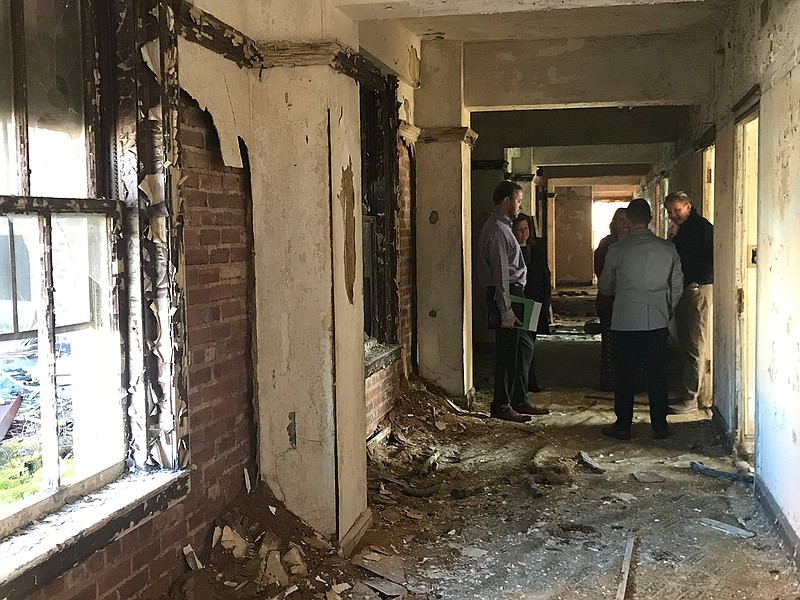 City planning staff members talk with developers during a recent walk-through of the Hotel Grim on North State Line Avenue in downtown Texarkana, Texas. (Photo courtesy the city of Texarkana, Texas)
