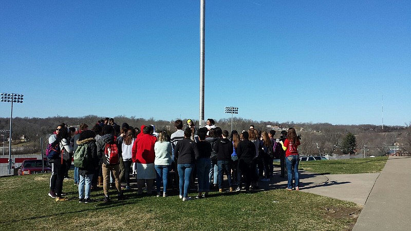 Approximately 50 students walked out at Jefferson City and gathered around the flag pole between JCHS and Nichols Career Center as part of the "National School Walkout" protest Wednesday, March 14, 2018.