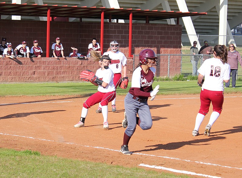 Arkansas High pitcher Kaitlyn Fortenberry turns to check a runner at first base after catching a popup between teammates Jordan Stanley (8) and Alyssa Smith (18) during the second inning of the Lady Backs' game against Maud on Tuesday at Lady Back Field.
