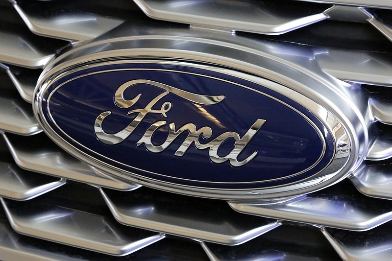 FILE- This Feb. 15, 2018, file photo shows a Ford logo on the grill of a 2018 Ford Explorer on display at the Pittsburgh Auto Show. Ford, with a sagging U.S. market share and one of the oldest vehicle lineups in the industry, is promising to revamp three-quarters of its models in the next two years. The move was detailed at a presentation on Thursday, March 15, at Ford's product development center in Dearborn, Mich. (AP Photo/Gene J. Puskar, File)