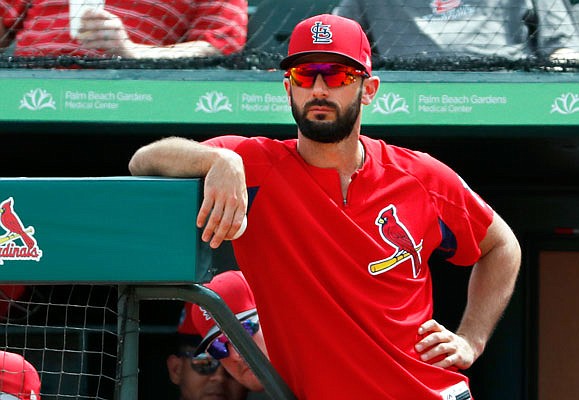 Matt Carpenter watches a spring training game against the Twins from the Cardinals dugout earlier this month in Jupiter, Fla.