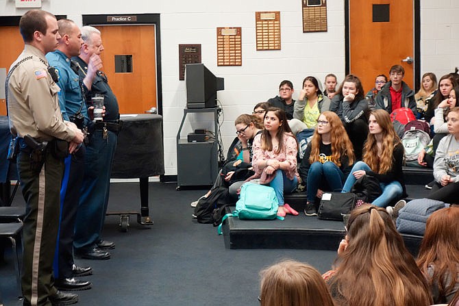 After bowing their heads for a moment of silence remembering 17 killed a month ago in a Florida school shooting, local law enforcement officers offered advice Wednesday to a group of Fulton High School students.