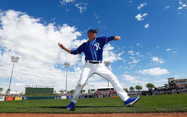 Actor Jim Caviezel warms up before throwing out the first pitch at Wednesday's spring training game between the Royals and the Cubs in Surprise, Ariz.