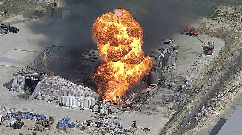 In this image from video by KDFW, a fire burns at the Tri-Chem Industries plan in Cresson, Texas. Officials said fears of another blast amid the toxic chemicals prevented crews from battling the blaze. (KDFW via AP)