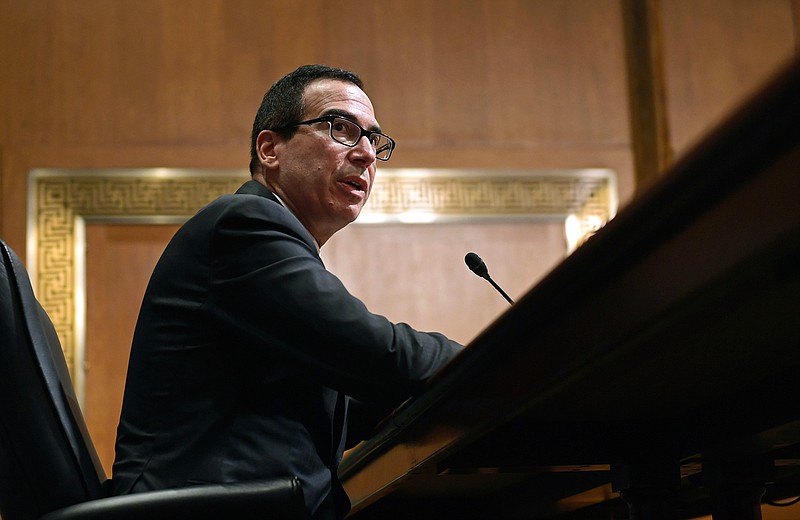 In this Feb. 14, 2018 photo, Treasury Secretary Steven Mnuchin testifies before the Senate Finance Committee on Capitol Hill in Washington. The Trump administration on Thursday imposed sanctions on 19 Russians for alleged interference in the 2016 U.S. presidential election, including 13 indicted by special counsel Robert Mueller as part of his Russia-related investigation.  The Treasury Department announced the sanctions amid withering criticism of Trump and his administration for failing to use the congressionally mandated authority to punish Russia for the election interference. Trump himself has been skeptical of the allegations.  (AP Photo/Susan Walsh)