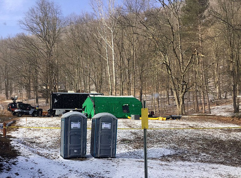 In this March 13, 2018 photo, FBI agents and representatives of the Pennsylvania Department of Conservation and Natural Resources set up a base off Route 555 in Benezette Township, Elk County, Pa., at a site where treasure hunters say Civil War-era gold is buried. (Katie Weidenboerner/The Courier-Express via AP)