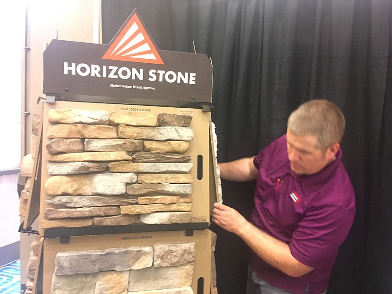 Ricky James of Acme Brick in Texarkana sets up part of a display Friday for the annual Texarkana Home Builders Association's Home and Garden Show. The show starts today at Texarkana, Texas, Convention Center on Cowhorn Creek.
