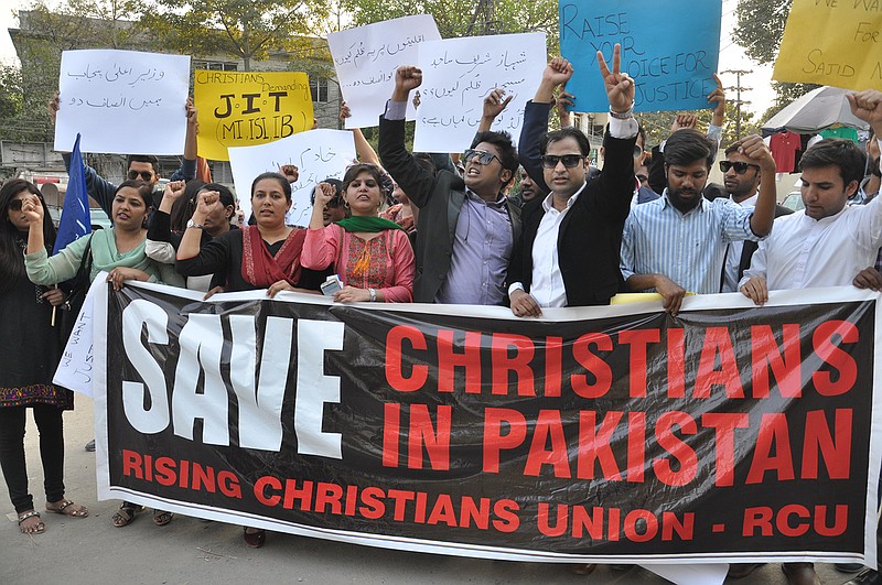 In this Monday, Feb. 28, 2018 photo, Pakistani students protest in favor of the Christian community in Hyderabad, Pakistan. Pakistan's blasphemy law terrifies minorities, quashes dissent and emboldens radicals, who use it to whip up extremism in the population and threaten those who oppose them. But now activists are calling for change in the law as Pakistan comes under increased pressure from the United States and other countries to do more to curb radicalism and militant groups. (AP Photo/Pervez Masih)