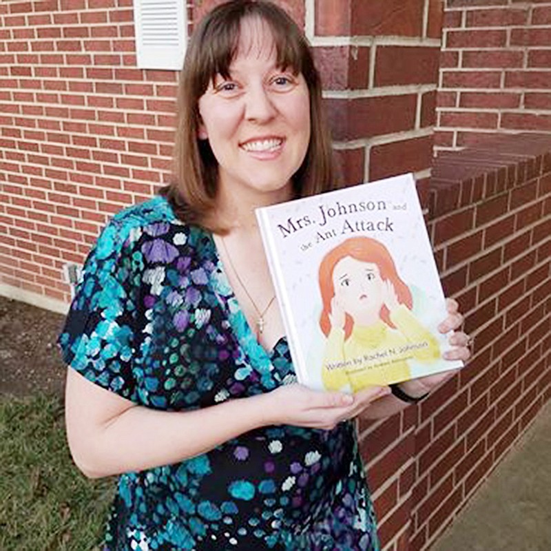 Rachel Johnson holds a copy of her book, "Mrs. Johnson and the Ant Attack." The book tries to give children the confidence to be critical thinkers and problem solvers.