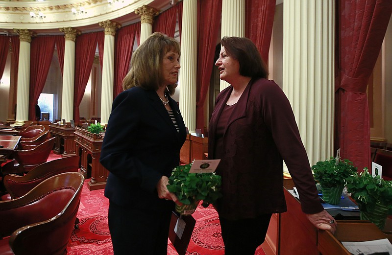 In this photo taken Thursday, March 15, 2018, state Sen. Toni Atkins, D-San Diego, right, talks with Senate Republican Leader Pat Bates, of Laguna Niguel, after the Senate session in Sacramento, Calif. Atkins will make history Wednesday, March 21, 2018, when she becomes the first woman and first lesbian to hold the California Senate’s top job. (AP Photo/Rich Pedroncelli)