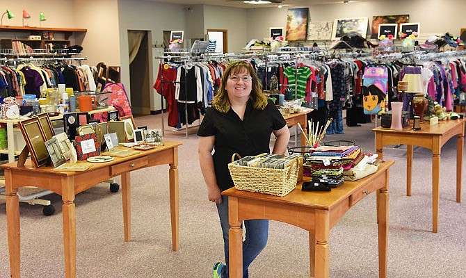 Barb Jones poses inside her recently opened shop, The Burlap Sack, located in the former Calena's Fashions in the JK Plaza in Holts Summit. The store is a consignment and resale shop and carries clothing and a number of household items.