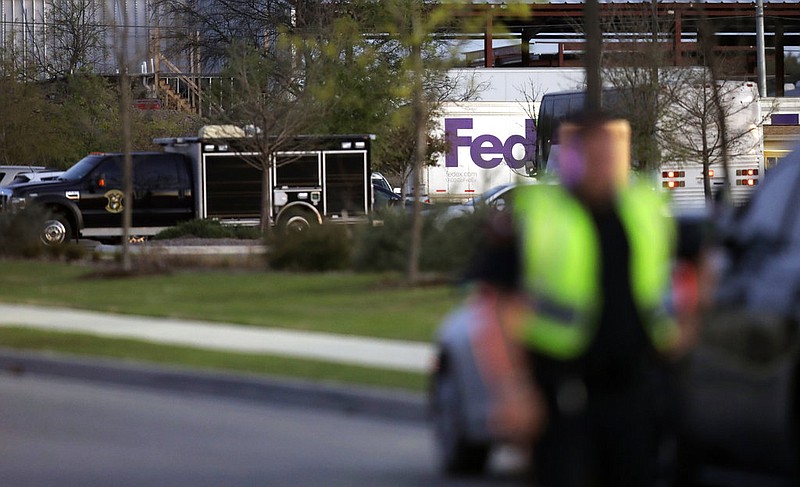 Emergency vehicles sit in front of a FedEx distribution center where a package exploded, Tuesday, March 20, 2018, in Schertz, Texas. Authorities believe the package bomb is linked to the recent string of Austin bombings.