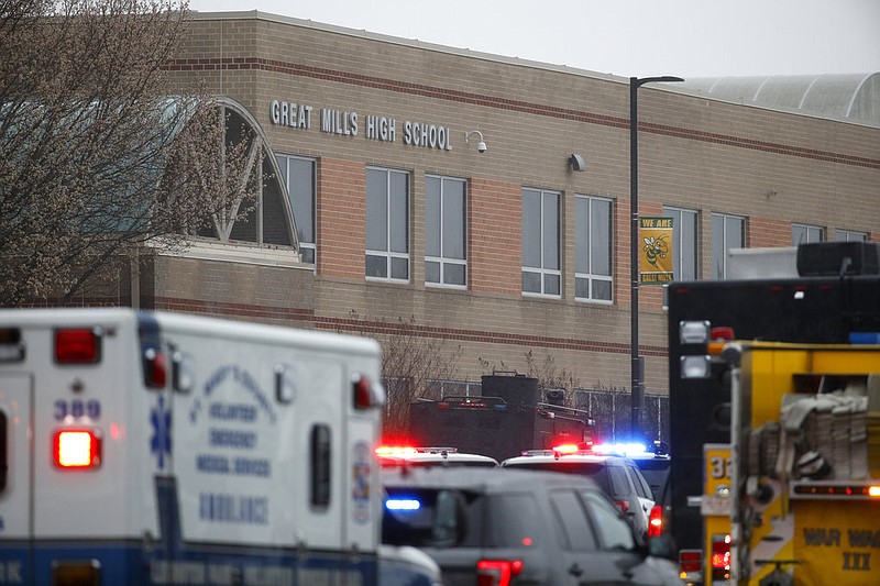 Deputies, federal agents and rescue personnel, converge on Great Mills High School, the scene of a shooting, Tuesday morning, March 20, 2018 in Great Mills, Md. The shooting left at least three people injured including the shooter. 