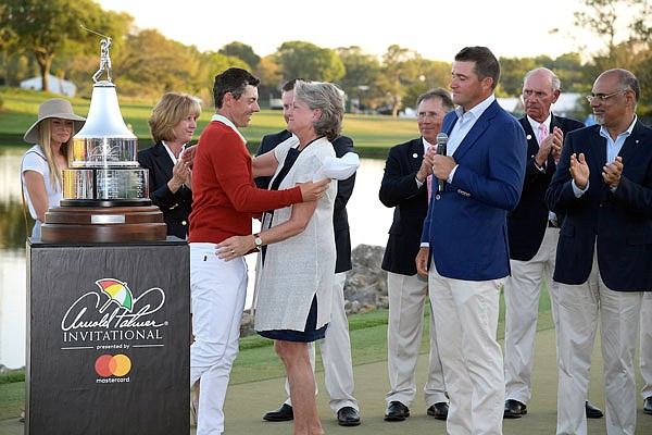 Rory McIlroy ( left) receives a congratulatory hug from Kit Palmer, Arnold Palmer's widow, after winning the Arnold Palmer Invitational on Sunday in Orlando, Fla.