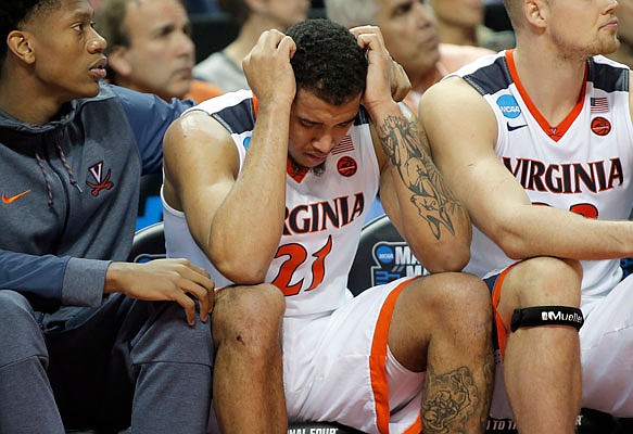 Virginia's Isaiah Wilkins (21) is consoled after fouling out during last week's loss to UMBC in the opening round of the NCAA Tournament in Charlotte, N.C.