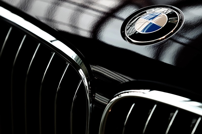 The logo of German car manufacturer BMW is pictured on a BMW 7 car prior to the earnings press conference in Munich, Germany, Wednesday, March 21, 2018. (AP Photo/Matthias Schrader)