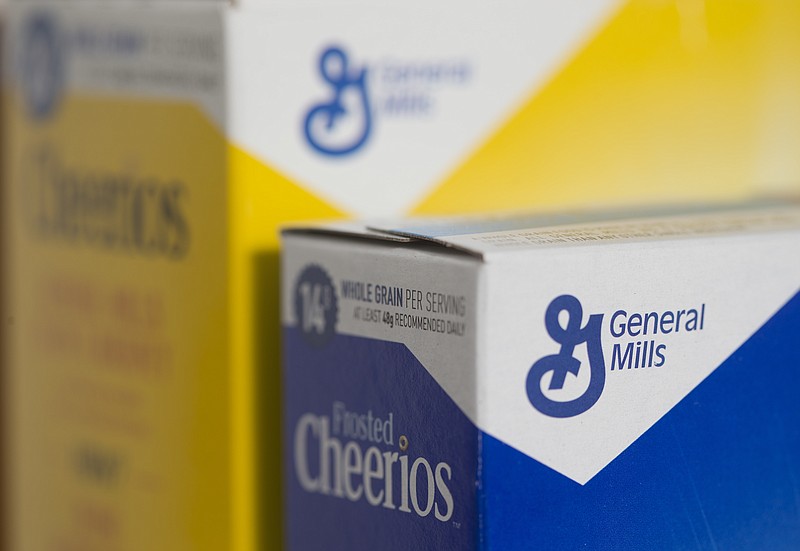 FILE- In this April 21, 2017, file photo, boxes of General Mills' Cheerios cereal are arranged for a photo in Surfside, Fla. General Mills Inc. reports earnings Wednesday, March 21, 2018. (AP Photo/Wilfredo Lee, File)