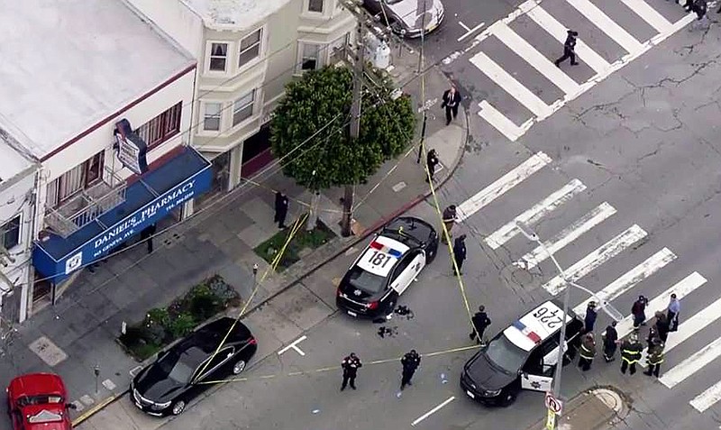 In this photo from video provided by KTVU-TV, San Francisco police officers cordon off the scene of a shooting that left an officer and a suspect wounded with non-life threatening injuries in the city's Mission District, Wednesday, March 21, 2018. The San Francisco Chronicle reported that the officer and a suspect were each shot in the leg during a shootout at about 4:20 p.m. (KTVU-TV via AP)
