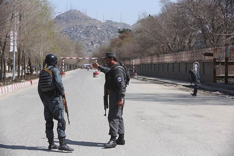 Police patrol the streets Wednesday after a suicide attack in front of Kabul University. Afghan officials are reporting a large explosion on the road to a Shiite shrine in the capital, where people had gathered to mark the Persian new year.