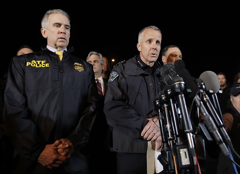 Interim Austin Police Chief Brian Manley, right, stands with other members of law enforcement as he briefs the media, Wednesday, March 21, 2018, in the Austin suburb of Round Rock, Texas. The suspect in a spate of bombing attacks that have terrorized Austin over the past month blew himself up with an explosive device as authorities closed in, the police said early Wednesday. (Eric Gay)
