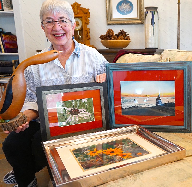 Rebecca Narramore of Linden, Texas, is shown with four of six works she submitted in the Spring Art Show in Hughes Springs, Texas. These four each won a ribbon.