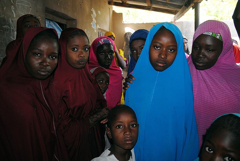 Aishat Alhaji , second, right, one of the kidnapped girls from the Government Girls Science and Technical College Dapchi who was freed, is photographed Wednesday in Dapchi, Nigeria, after her release. Witnesses say Boko Haram militants have returned an unknown number of the 110 girls who were abducted from their Nigeria school a month ago.