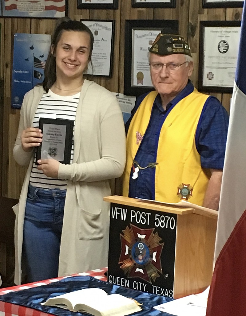 Sidni Davis of Queen City, Texas, is receiving a plaque and scholarship check for $200 from Atlanta VFW Post 5870  Commandant Bill Brockett for her third-place finish in the Patriot's Pen district level writing competition.  She is the daughter of Jessica and Sidney Davis of Queen City.