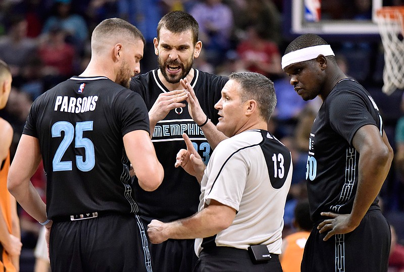 In this Feb. 28, 2017, file photo, Memphis Grizzlies forward Chandler Parsons (25), center Marc Gasol (33) and forward Zach Randolph (50) talk with referee Monty McCutchen during the first half of the team's NBA basketball game against the Phoenix Suns in Memphis, Tenn. McCutchen left his job on the floor during this season to become the league's vice president and head of referee development and training. With tensions high this season with both players and coaches, he's been conducting respect-for-the-game sessions with each team in hopes of creating a stronger working relationship.