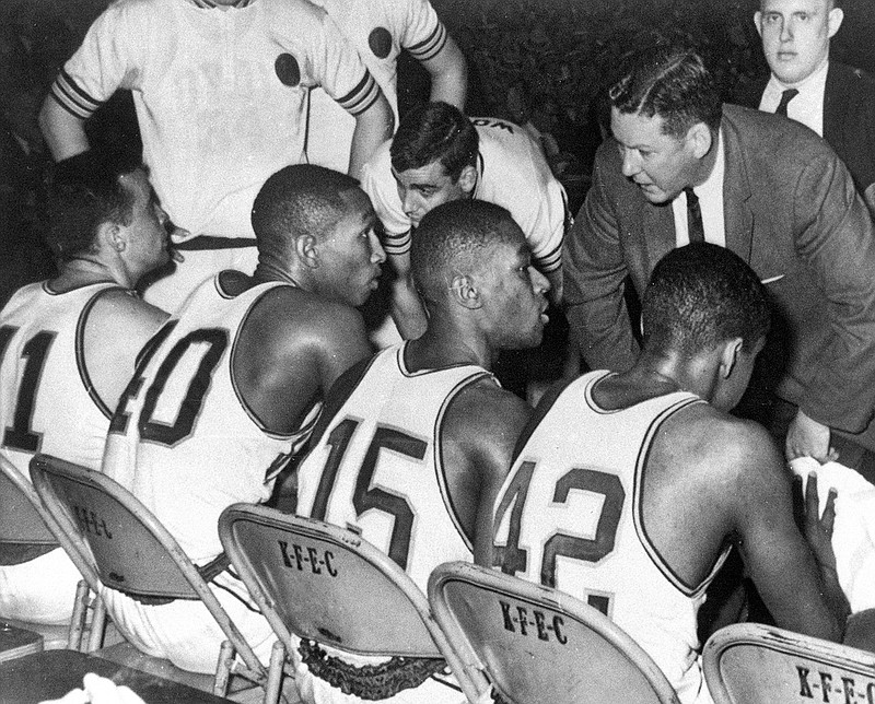 In this March 23, 1963, file photo, Loyola coach George Ireland, right, bends over to issue orders to his team that was trailing Cincinnati in the final game of the National Collegiate basketball championship at Louisville, Ky. Players, from left, are John Egan, Vic Rouse, Jerry Harkness and Ron Miller. The Ramblers play Nevada on Thursday after two thrilling wins to reach the Sweet 16, earning more wins this season than the team that won the 1963 title.