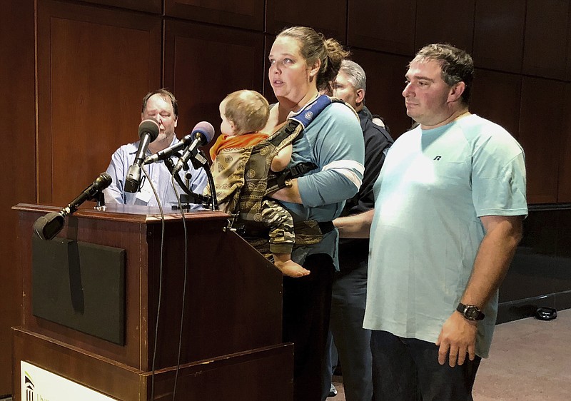 Parents of Great Mills high school student Jaelynn Willey, Melissa Willey, and Daniel Willey, hold one of their nine children during a press conference at Prince George's Hospital Center in Cheverly, Md., Thursday, March 22, 2018. Melissa Willey told news reporters that her daughter, Jaelynn Willey, 16, who was shot when a classmate opened fire inside their Maryland high school, has "no life left in her." She said Jaelynn would be removed from life support during the evening. (Marissa Lang/The Washington Post via AP)