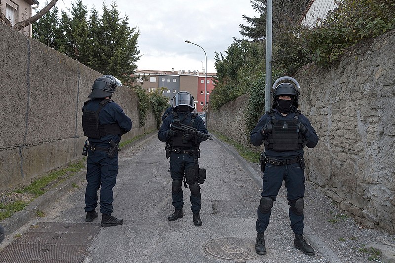 Police cordons off the area of a raid at the suspect's residence involved in a shooting, in Carcassonne, southern France, Friday, March 23, 2018. A gun-wielding extremist unleashed bloodshed in a quiet corner of southern France on Friday, killing three people as he hijacked a car, opened fire on police and took hostages in a supermarket. (AP Photo/Jean-Paul Bonincontro)