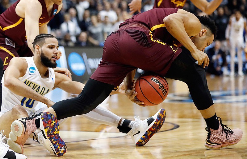 Loyola-Chicago guard Marques Townes (5) steels the ball against Nevada forward Caleb Martin (10) during the first half of a regional semifinal NCAA college basketball game, Thursday, March 22, 2018, in Atlanta. (AP Photo/David Goldman)