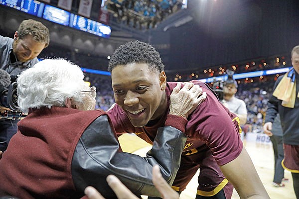 Sister Jean Dolores Schmidt embraces Loyola of Chicago guard Cameron Satterwhite after a regional semifinal game against Nevada on Thursday in Atlanta.