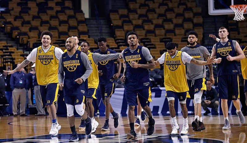West Virginia's Jevon Carter (2) and Daxter Miles Jr. (4) lead the team as they run during practice at the NCAA men's college basketball tournament in Boston, Thursday, March 22, 2018. West Virginia faces Villanova in a regional semifinal on Friday night. (AP Photo/Charles Krupa)