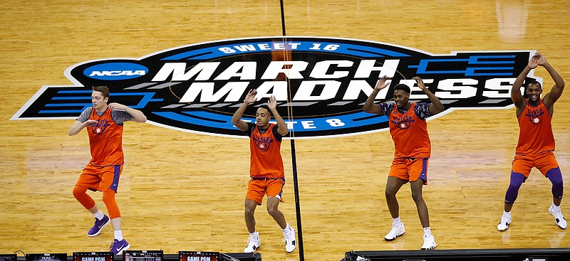 Clemson players run on the court during practice at the NCAA men's college basketball tournament, Thursday, March 22, 2018, in Omaha, Neb. Clemson faces Kansas in a regional semifinal on Friday. (AP Photo/Charlie Neibergall)