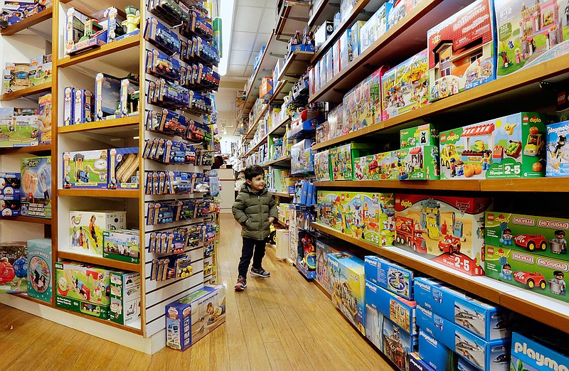 In this Monday, March 19, 2018, photo, a young customer checks out the merchandise at Mary Arnold Toys in Manhattan's Upper East Side. Mary Arnold, a nearly 90-year-old store in Manhattan, is thriving along with many other small and independent toy stores, even as Toys R Us is going out of business and more consumers shop online. (AP Photo/Richard Drew)